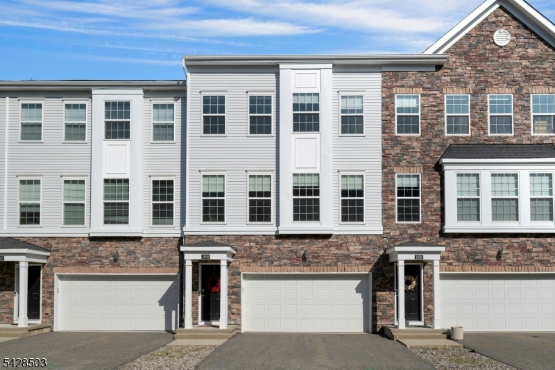 Welcome to this beautifully maintained townhome on sought after Devon Lane in The Hills, quietly tucked away on a quiet cul-de-sac with just a handful of homes. Desirable Pinehurst model, offers a perfect blend of space, comfort and modern design. You're greeted with rich hardwood floors and an abundance of natural light streaming through oversized windows. The versatile first-floor layout features a spacious family room with a full bath- ideal for a guest suite- with direct access to private patio overlooking a serene open grassy area. Convenient garage access completed this level.The main floor is designed for effortless living and entertaining, showcasing an open-concept layout anchored by a stunning custom kitchen. Highlights include 42in raised-panel cabinetry, granite countertops, large center island, stainless-steel appliances and pantry. The kitchen flows seamlessly into the expansive dining and living areas with access to a private rear deck- perfect for morning coffee or evening relaxation. Upstairs the primary suite offers a peaceful retreat with walk-in closet and a spacious ensuite with double sinks, water closet and large shower. Two additional generously sized bedrooms, a full bath and a convenient laundry area complete the upper level. Additional features include a two-car garage, private driveway, and a walkable, well-maintained community. Ideally located with easy access to major roadways.