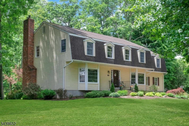 Welcome to this majestic center hall Colonial situated on spectacular professionally landscaped property!Inviting front entry leads to welcoming Foyer.LR & FR have been modified to create unequaled "Great Room", offering an expansive space w/a multitude of decorating possibilities.Also boasts full wall brick FP w/woodstove & slider leading to deck overlooking beautiful rear grounds.Formal DR leads to new chef's kitchen! Stylish yet functional features inc. wood cabinetry w/leathered granite counters, subway tile backsplash & porcelain tile flr.Also features center isle w/brkfst bar & leathered granite top, triple pendant light + recessed lighting, SS appl. & decorative farmhouse sink + convenient direct entry to 2 car gar. Also boasts door to the deck w/built-in arbor & overlooking rear grounds.Primary Ste inc. expansive BR, full BA w/tub & separate shower + 2 WI closets.BR's 2,3 & 4 all generously proportioned w/ample closets & Bonus Rm,currently used as BR 5 (4 br septic) offers addit 2nd flr living space.Boasts convenient 2nd flr Laundry Rm!Fin. LL w/daylight window boasts areas used as Media Rm &Game/Play Rm.Large storage & utilitiy rms also found in LL. This property is a gardener's dream w/mature trees,bushes & speckled w/colorful perennials &garden beds throughout.Enjoy the bucolic setting by the rear yard firepit!Many addit. features inc. new multi zone boiler 2024, paver walkways & patio, storage shed...a very special home & property you won't want to miss!