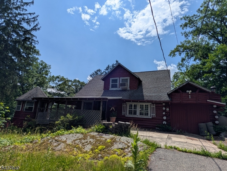 This unique log home is located in lower West Milford with convenient commute to all schools and major highways.  The house features 3 bedrooms, one bath, large living room with stone fireplace, nice size kitchen with formal dining room and is easy walk to the community in ground pool.  New septic will be installed prior to close and the home features newer boiler, hot water heater and water conditioning systems.  Large covered front porch with enclosed log gazebo provide additional entertaining/multi use spaces.