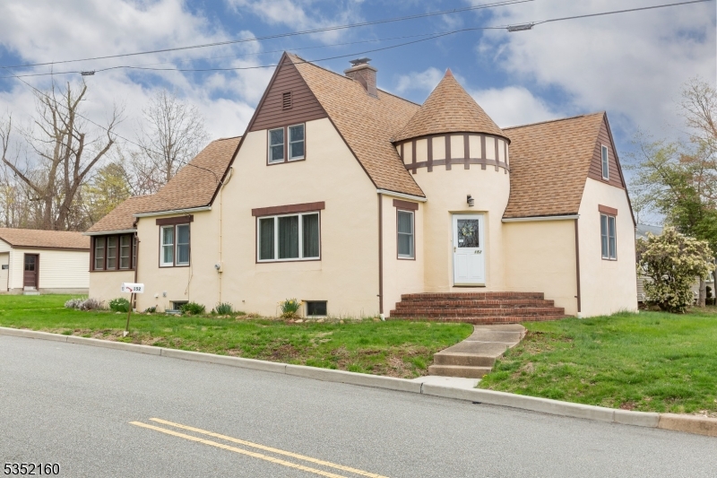 STORYBOOK CHARM MEETS ENDLESS POTENTIAL IN THE HEART OF CEDAR KNOLLS!  Welcome home to 152 Ridgedale Avenue! This meticulously maintained Tudor-style gem, brimming with character is set on a generous, luscious, idyllic corner lot in the heart of Cedar Knolls. With low taxes, unbeatable convenience to major highways, NYC transit, and shopping, this home is one you don't want to miss!  Step through the arched front entry into a spacious, sun-filled layout featuring a formal Living Room with a brick wood-burning fireplace with floor level hearth, and several windows allowing tons of natural radiant light to shine through! The Living Room flows directly into the separate formal Dining Room ideal for entertaining. The Kitchen boasts stainless steel appliances and plenty of charm, while a rear vestibule entrance adds extra function and flexibility to your daily flow. This home offers three spacious bedrooms and one full bath, plus a full unfinished basement and a walk-up attic that presents a blank canvas perfect for a future primary suite or bonus living space. Step into the enclosed sunroom, surrounded by windows that fill the space with natural light and offer a serene view of the property. Outdoors, the property continues to impress with an expansive driveway leading to a detached two-car garage, providing ample space for vehicles, storage, or even a workshop. This home has been lovingly cared for and is ready for its next chapter - Don't miss out on a chance to call this HOME!