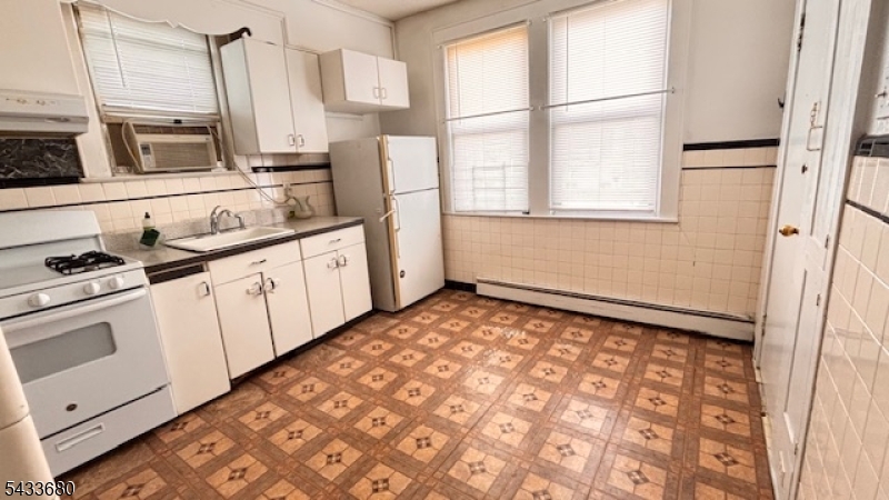 Large and brightwith several windows bringing in a natural light second floor living offering an eat in kitchen, large living room and formal dining room. 2 Bedrooms,  a laundry room with hook ups makes this a very large e desirable unit which  tenant can bring their own machines and refrigerator. Window air conditioners (3) installed. No parking or use of backyard. Great location just steps away from Harrison High School. Required full application. Tenant responsible to payfor electricity and gas for the unit.  Very close walking distance of 3 minutes to West Hudson Park, shopping, diverse restaurants, doctors, pharmacies, High School a few steps away - you can find all you need in this Town within a few steps away from the unit. Public Transportation around the corner. Path Station an average of 18 minutes walking. Hardwood flooring. An extra small bedroom plus an enclosed porch add more living space as needed