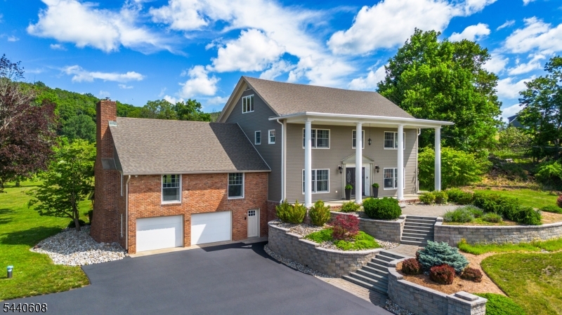 AN EXTRAORDINARY ESTATE RETREAT ON OVER 3 LANDSCAPED ACRES & RECREATIONAL SWIM POND! Enter through CHARMING VINTAGE  doors into a HOME FILLED w/ CHARACTER, SPACE & TIMELESS APPEAL. First floor features a SPACIOUS COUNTRY KITCHEN w/ MAPLE CABINETRY, ABUNDANT COUNTER SPACE, a STAINED-GLASS ACCENT WINDOW & BRICK FIREPLACE. The IMPRESSIVE GREAT ROOM has BEAMED CEILINGS, STONE FIREPLACE INSERT & EXPANSIVE WINDOWS OVERLOOKING the PRIVATE BACKYARD. A THREE-SEASON SUNROOM with PATIO ACCESS, FORMAL DINING area,DEN/OFFICE, LIVING ROOM w/GLASS DOORS, UPDATED FULL BATH and CUSTOM LAUNDRY ROOM complete the 1st floor. Upstairs the PRIMARY EN SUITE includes a PRIVATE BATH & MULTIPLE WALL WARDROBES, along with 3 ADDITIONAL BEDROOMS & SECOND UPDATED FULL BATH with HEATED FLOORS & DOUBLE VANITY. The third floor offers a WALK-UP ATTIC with a full bath and 2 VERSATILE ROOMS for ADDED LIVING SPACE. The WALKOUT lower level features an EXERCISE ROOM & MASSIVE READY TO BE FINISHED AREA for FUTURE EXPANSION. 2 CAR GARAGE w/ BUDERUS HEATING SYSTEM adds FUNCTIONALITY. With OVER 5900 SQ FT + 1900 SQ FT in the BASEMENT, this METICULOUSLY MAINTAINED home is COMPLEMENTED by an EXTRAORDINARY OUTDOOR SETTING. A PRIVATE RECREATIONAL SWIM POND w/ DEPTHS up to 6 FT, WATERFALLS, GRANITE BOULDERS, AQUATIC PLANTS, KOI FISH, PATIO & POND HOUSE, offers RESORT LIKE SETTING for SWIMMING, FLOATING & ENJOYING the OUTDOORS. NEWER WATER HEATER, EXPANSION TANK, WELL PUMP, LED BASEMENT LIGHTING. UPDATED SEPTIC at CLOSING.