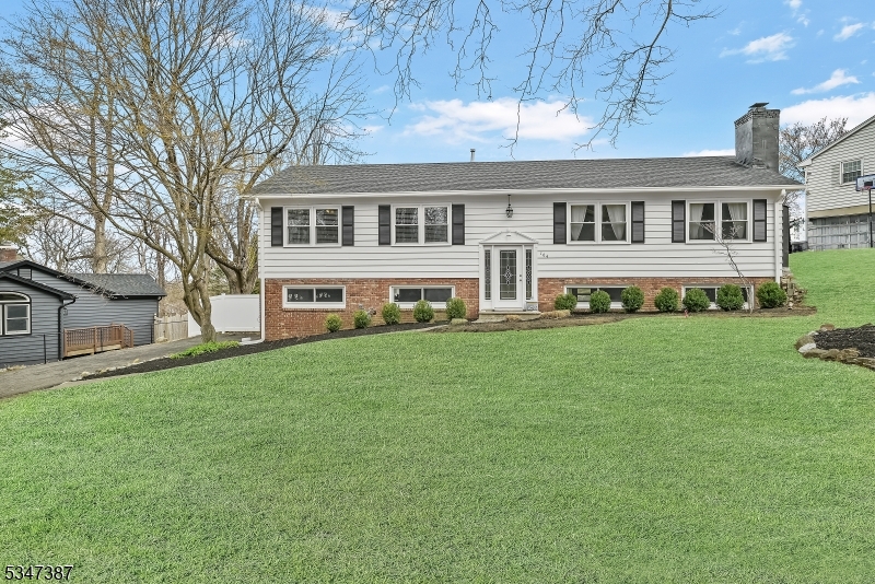Welcome to this updated 4-bedroom, 2-bath bi-level home in the highly sought-after Alpine Section of Lake Mohawk. Thoughtfully renovated in 2018 & 2024. Step into the bright & spacious living room, where large sun-filled windows provide the perfect backdrop for breathtaking evening sunsets. The open-concept dining area flows seamlessly into the beautifully upgraded kitchen, featuring stainless steel appliances, granite countertops, & recessed lighting. Hardwood floors run throughout the home, adding warmth to every space. The primary bedroom boasts an en-suite bath, while custom-designed closets in two of the bedrooms offer optimal organization. Both bathrooms have been tastefully renovated, ensuring modern style & convenience. The walkout finished basement provides a large, versatile space. The well-appointed laundry room, complete with a washer, dryer, cabinetry, & granite countertops, adds efficiency & convenience. The freshly painted exterior complements an oversized two-car garage with electric doors. Outdoor living is at its finest with a deck, a custom fire pit, & a stunning paver stone patio with hardscape walls & stairs, all enclosed by a privacy fence. This home is equipped with central A/C for year-round comfort. Included is portable generator and electrical hookup.  Lake Mohawk offers waterfront dining, lake activities, & more. Conveniently located near major highways & transportation, this is an exceptional opportunity to enjoy lake living at its best!