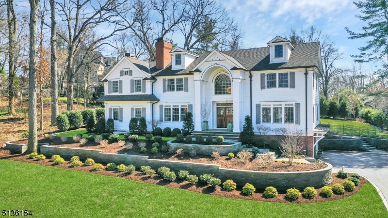 Stunning architectural details, desirable floor plan and large professionally landscaped property makes this custom Chatham home one of a kind. Built in 2017 and located on a premier street in the Upper Washington Avenue section of Chatham Township this  meticulously maintained home offers privacy on .72 acres with 4 levels of tranquil living space. The gracious exterior includes copper trim and beautifully landscaped gardens which welcomes you into the stunning two-story entry foyer. The formal DR and LR has a unique silver-leafed and Venetian plastered coffered ceilings respectively. The kitchen is spacious and sun-filled with custom cabinetry, professional-grade SS appliances and a large island with seating. The kitchen flows into a large FR with a gas fireplace and 2nd floor staircase. The exterior patio and expansive flat Southern exposed back yard is a breeze from the kitchen/dining area. There is a 1st floor separate office and a spacious en-suite BDRM with a full bath and large closet. The 2nd floor has 4 BDRS, 3 full BA and a LNDR room.The primary suite has a 2- sided gas fireplace shared by a sitting room with vaulted ceiling. There are 2 private WIC with custom built-ins and a gracious en-suite bathroom with a soaking tub spa-like shower private WC and a double sink vanity. The 3rd level is finished with a full bath. The lower level is fully finished with gym, bar, entertainment area and wood burning FP. 3 car garage, full house generator, & humidification system.