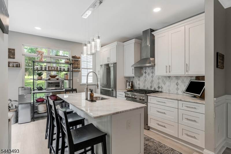 Welcome home to this beautifully updated 2-3 bedroom townhome that perfectly combines style, comfort, and functionality.  Step inside to soaring high ceilings and an inviting open-concept layout centered around a cozy gas fireplace.  The stunning, renovated kitchen has been thoughtfully opened up, creating the perfect space for entertaining and everyday living.It boasts a large marble center island with counter seating, custom cabinetry and backsplash and offers a sliding glass door to the back patio for ease of grilling and wonderful natural light. The first floor bedroom can also serve as a spacious office with a private closet.  The 2nd level offer 2 spacious ensuites with custom wood accent walls, walk in closets and a magnificent updated spacious primary bath complete with a soaking tub and double vanity. The full finished basement provides exceptional additional living space, ideal for a family room, home office, gym or guest area.  A one car garage adds convenience, while numerous updates throughout the home offer modern appeal and peace of mind.  Move-in ready and meticulously maintained, this townhome in desirable Loft Farm complete with a community pool and playground is the perfect place to call home. This wonderful community is walking distance to downtown Martinsville which hosts many restaurants and conveniences as well as being a mile away from Chimney Rock Crossing shopping complex with Whole Foods and multiple other retail outlets.