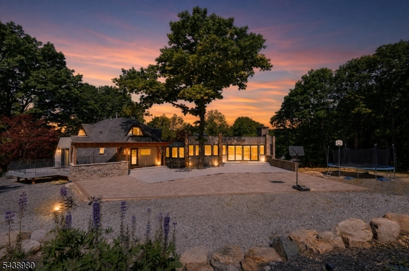 ONE-OF-A-KIND custom contemporary home set on 7+ private acres backing up to protected watershed/state land. This distinctive dome-style home with a dramatic stone addition offers 5 bedrooms, 4.5 baths and an exceptional floor plan designed for comfortable living and entertaining. The impressive first-floor primary suite features an 18x9 walk-in closet and luxurious bath with heated floors, steam shower, and soaking tub.The stone addition showcases soaring 25-foot ceilings, a custom-crafted home office, expansive library, media room, and multiple living spaces filled with character and natural light. The recently updated kitchen and bathrooms blend modern convenience with the home's unique architectural design. Four fireplaces/wood burning/Pellet stoves provide warmth and ambiance throughout. Additional highlights include a large mudroom, recessed and track lighting, walkout basement, and private living quarters with a separate entrance, ideal for guests.Outdoor features are equally impressive with a 1,000+ sq. ft. stone patio, two decks overlooking the private backyard, gardens, fruit trees, wild raspberries, livestock enclosure, and recently cleared areas suitable for a pool or sports court. Additional upgrades include a whole-house water filtration system, newly paved driveway, detached 3-car garage, and attached 1-car garage. Conveniently located near Route 23, golf courses, Mountain Creek, Crystal Springs, and approximately one hour from NYC.   *4 bedroom septic*