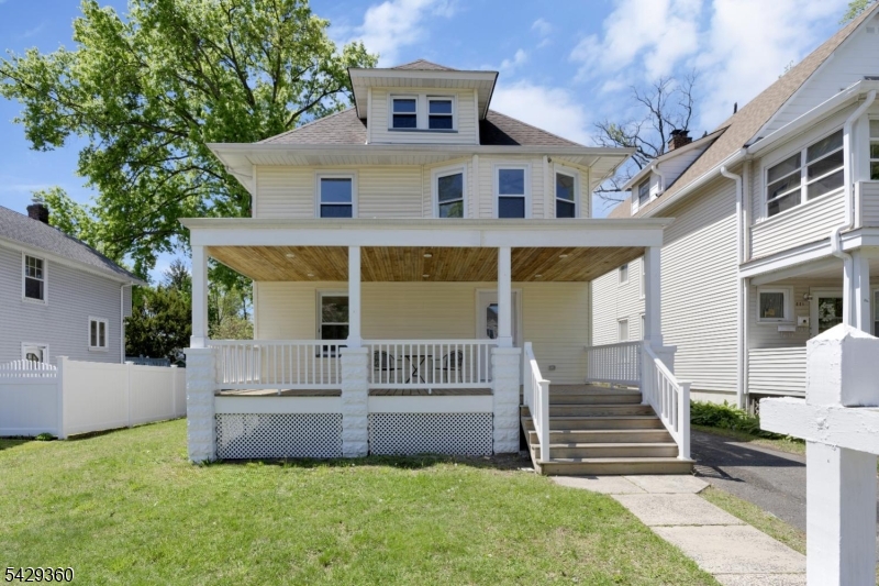 Welcome to 219 Lincoln Avenue, a beautifully renovated 4-bedroom, 2-bath Colonial offering timeless charm and modern functionality in the heart of Dunellen. The expansive covered front porch with its warm wood-paneled ceiling is the perfect spot to sit and relax. Inside, the home features a bright, open floor plan with wood floors throughout. The spacious living room flows into a formal dining area and an updated eat-in kitchen, complete with granite countertops, stainless steel appliances, and a center island with seating. The main level also includes a full bathroom, high ceilings, and oversized windows that bring in abundant natural light. Upstairs, you'll find four generously sized bedrooms, along with a newly renovated hall bathroom. A standout feature of the home is the unfinished attic, already framed and ready to be transformed into additional living space-whether a home office, playroom, or private retreat. Step outside to enjoy the large deck overlooking the flat backyard. Move-in ready with room to grow, this home combines classic style with modern updates in a convenient location close to shops, dining, and transportation.