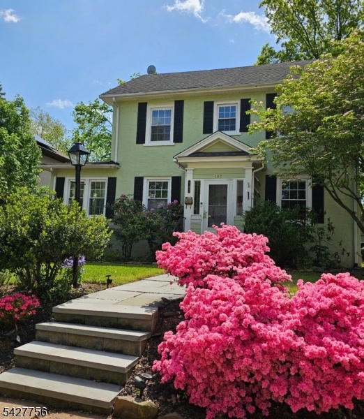 More pix coming of this Beautifully situated Colonial in the highly sought-after North Plainfield neighborhood. This charming home features gorgeous wood floors throughout. A welcoming entrance vestibule leads into a spacious living room complete with a wood-burning fireplace and custom built-in wall unit. Just off the living room, enjoy a sun-drenched sunroom or home office with elegant French doors. The main level also offers a large formal dining room and an eat-in kitchen conveniently located down the hall. Upstairs, the second level boasts three generously sized bedrooms and a full bath. The attic, accessible via pull-down stairs, provides an abundance of additional storage space. The full basement includes a water softener and  the added convenience of a toilet offers great potential. Outside, you'll find a fenced-in yard and a large two-car garage, perfect for parking and storage. Enjoy a prime location close to shopping, major highways, and easy access to New York City transportation. Sold as - is Buyer responsible for town Certifications and Fire Inspections.