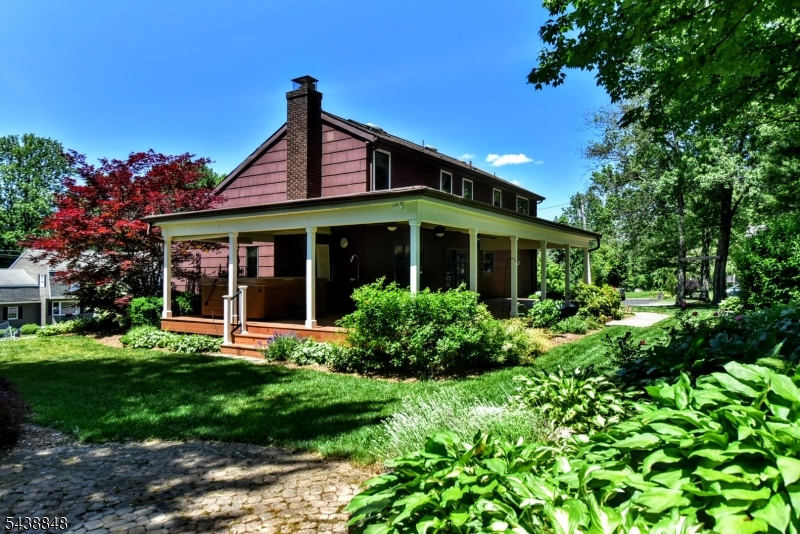 If you love to entertain this Tudor style center hall colonial is for you! Situated on a corner lot, as you enter the foyer to your left are glass French doors leading to a formal living room and a formal dining room, with large windows to let in the light. To your right is a Combined Craft-Office-Laundry-Pantry. The family room with wainscoting a wood-burning brick fireplace, beamed ceiling, and hickory flooring are just a step away. That leads into the beautiful custom kitchen with plenty of cherry cabinets stained ebony with chocolate glaze, granite countertops and a large center island with plenty of drawers. some of the cabinets have glass doors and shelving as well as lighting inside. All Thermador appliances including an extra wall oven in addition to the 6 burner stove/oven and refrigerator. There's a built in pantry as well. This truly is the heart of the home. Upstairs is a large hallway with 4 good sized bedrooms all but one have WIC's Primary has 2! As well as 3 showerheads in the en-suite. The basement is finished with high ceilings, recessed lighting and tile floors. Just off the garage is a large L shaped storage area and a workshop. Picture yourself relaxing with family and friends in your 7-person hot tub on the covered wrap around trex deck with ceiling fans. Surrounded by your own little oasis. There is even a chicken coop and an extra storage shed with electric behind the wooden fence. So much attention to details and pride of ownership!