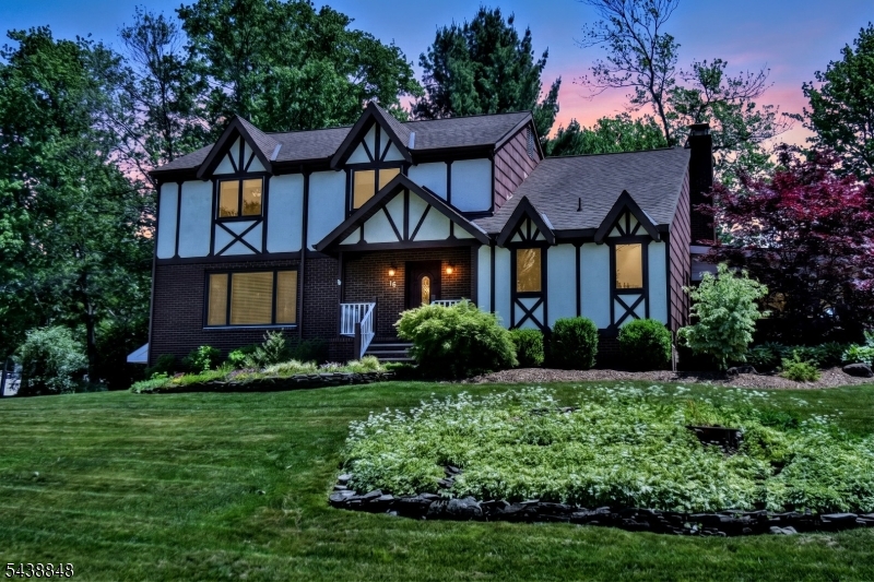 If you love to entertain this Tudor style center hall colonial is for you! Situated on a corner lot, as you enter the foyer to your left are glass French doors leading to a formal living room and a formal dining room, with large windows to let in the light. To your right is a Combined Craft-Office-Laundry-Pantry. The family room with wainscoting a wood-burning brick fireplace, beamed ceiling, and hickory flooring are just a step away. That leads into the beautiful custom kitchen with plenty of cherry cabinets stained ebony with chocolate glaze, granite countertops and a large center island with plenty of drawers. some of the cabinets have glass doors and shelving as well as lighting inside. All Thermador appliances including an extra wall oven in addition to the 6 burner stove/oven and refrigerator. There's a built in pantry as well. This truly is the heart of the home. Upstairs is a large hallway with 4 good sized bedrooms all but one have WIC's Primary has 2! As well as 3 showerheads in the en-suite. The basement is finished with high ceilings, recessed lighting and tile floors. Just off the garage is a large L shaped storage area and a workshop. Picture yourself relaxing in your 7-person hot tub on the covered wrap around trex deck with ceiling fans. Surrounded by your own little oasis. There is even a chicken coop and an extra storage shed with electric behind the wooden fence. So much attention to details and pride of ownership!