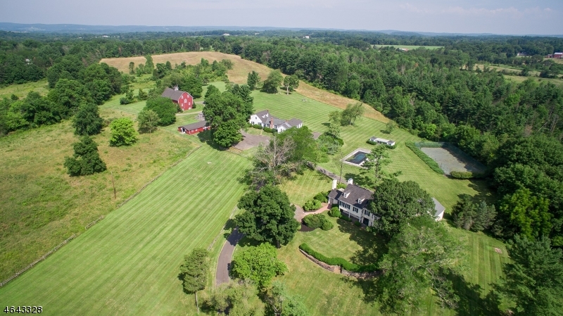 A meandering private drive leads you to this bucolic 83 acre historic farmstead located in Bedminster Hunt Country. This country compound includes the 5 bedroom turn-of-the-last-century main residence, a large cottage updated in 2013, 4-stall barn and the barn complex. Built in the classic style of banked barns, the magnificent red gambrel-roofed barn houses a two-bedroom caretaker?s apartment in addition to a tractor garage, heated workshop, paint shop, and equipment garage.  Lush rolling landscape and pastures. A skeet house for the enthusiast. Pool and tennis court. The property does not have land preservation restrictions. May have potential for sub-division.