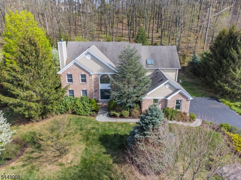 Stately Colonial, Understated Elegance! Nestled in one of Denville's most desirable neighborhoods, this home offers an upscale lifestyle on a quiet Cul-De-Sac. Prominently set on a large, level lot backed against a protected wooded area. Bright, open floor plan. Many high end features throughout. A grand home accented w/architectural details; high ceilings, wainscoting, curved walls & moldings. A showcase home with several customizations! Paramount Homes, Georgetown I floorplan with enlarged layout & added square footage give this home an edge. Updated kitchen w/coriander countertops & gourmet SS appliances. Cathedral ceilings & floor to ceiling windows in Family Room. Formal Dining & Living Rooms bookend the striking 2 story Foyer w/custom made stained glass window & chandeliers. Entertain with Flair! Extra bdrm/office on 1st floor. Upstairs, the primary suite features a large bath, 2 walk-in closets & sitting area. 3 more bdrms & bath. Full basement w/high ceilings- bonus living or storage plus oversized 3 car garage. Glass sliders to deck & landscaped backyard oasis offers a ton of privacy amidst mature trees & perennial gardens. Great location, just mins from Union Hills Shopping Center, Denville's bustling DWTN, Morristown Green, NYC-Direct transport & easy access to major hwys. Public utilities.