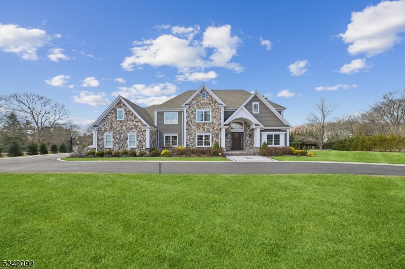 Welcome home to this stunning center-hall Colonial that combines luxury, comfort and style from the moment you arrive. Nestled on a beautifully landscaped 1.53-acre lot in a highly sought-after neighborhood, this East-facing six year-old home offers exceptional craftsmanship, high ceilings, and gorgeous millwork throughout. The gourmet EIK is a chef's dream, featuring soft-close cabinetry, top-of-the-line stainless steel appliances, two center islands, Quartz counters and a butler's pantry. Relax in the family room featuring coffered ceilings and a gas fireplace or host loved ones in the elegant dining room. This level also includes a convenient guest suite with a full bath. Upstairs you'll discover two primary suites. The main suite features a tray ceiling, see-through fireplace and a spa-like bath. Additional highlights include 1st & 2nd floor laundry, a mudroom, 4-car garage w/epoxy flooring and 5-zone HVAC. The amazing finished basement is an entertainer's dream and includes a large rec. room with a billiard's table & shuffleboard, a fully equipped home theater w/seating for 9, bar/lounge area, a fully-equipped home gym & another full bath. The large yard features mature landscaping and a covered patio with a smokeless fire pit. This extraordinary home was recently painted and also features a walk-up attic, Hardie Plank siding, Andersen windows and a newer circular driveway w/exterior lighting. Located close to shopping, top-rated schools & easy access to major highways.