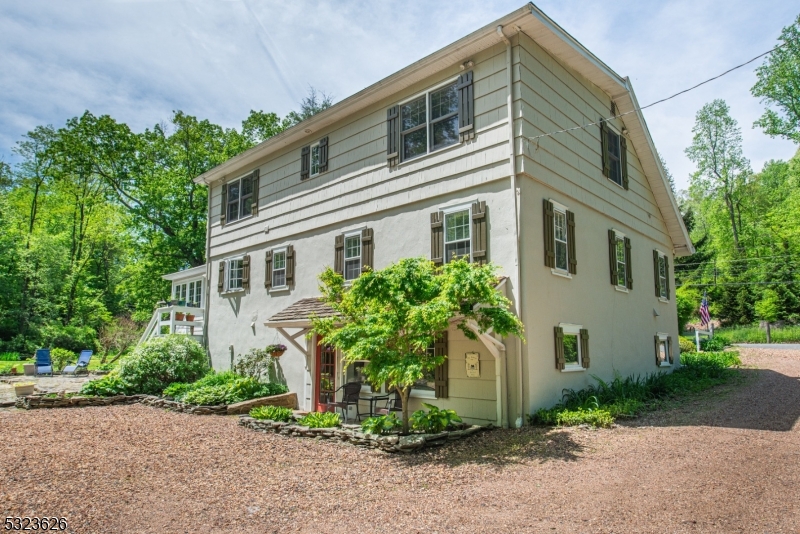 Discover a rare opportunity to own a private, wooded retreat that blends the beauty of nature and comforts of modern living. This charming 4 bedroom, 3 bath residence offers timeless appeal. From the moment you enter the property, its pond and a gently winding stream add a sense of calmness, with large outdoor space for activities. The heart of the home is the renovated kitchen complimented with an abundance of counter space, updated appliances, and an intuitive layout making cooking and entertaining a pleasure. Unwind in the sunroom, a bright and cheerful space that allows you to enjoy all four seasons from the comfort of indoors. Overall space is a major advantage with generously sized bedrooms, ample closet space and additional storage. The home's primary suite has been thoughtfully enhanced with a completely updated ensuite bath, featuring spa inspired touches including custom tile, updated fixtures, and a relaxing ambiance. Three additional bedrooms provide ample space for guests or a home office setup. Downstairs, the fully finished walkout basement offers bonus space with access to the backyard equipped with a gazebo and a sports court. Best of all, this one-of-a-kind home is located in the highly sought after West Morris Central (WMC) School District, known for its academic excellence. Come experience the magic of this home and imagine the lifestyle it could offer.