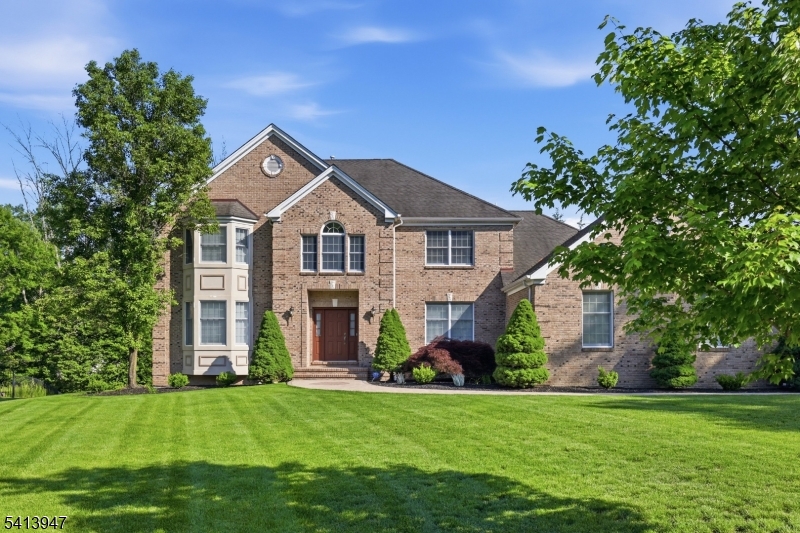 A winding paver front walk leads to this brick front center hall colonial with welcoming 2 story foyer with ceramic tile flooring leading to formal dining room with tray ceiling and hardwood flooring.  Step down formal living room leads to family room with wood burning fireplace/marble surround, recessed lighting and hardwood floors open to eat-in kitchen.  Large kitchen offers breakfast area, center island, granite counter tops, maple cabinets, pantry and sliders to newer composite deck overlooking fenced yard.  First floor also features a full bath adjacent to first floor office/bedroom, garage entrance, laundry and full bath.  Sweeping staircase leads to primary suite with vaulted ceiling and full sized walk-in closet with door to unfinished storage above garage and bath with dual vanities, jetted tub and stall shower.  Three additional spacious bedrooms and large guest bath with double vanity and tub shower, as well as pull down stairs to attic storage complete the 2nd floor.  The fully finished walk-out basement leads to a patio area and stairs to 1st floor deck.  Also, a full bath with tub shower and wet bar area.  Highly desirable area, convenient to everything - shopping, dining, NYC, Newark Airport, NJ Transit trains and buses and so much more!  Excellent schools!! Fireplace never used - sold as-is, no known defects.