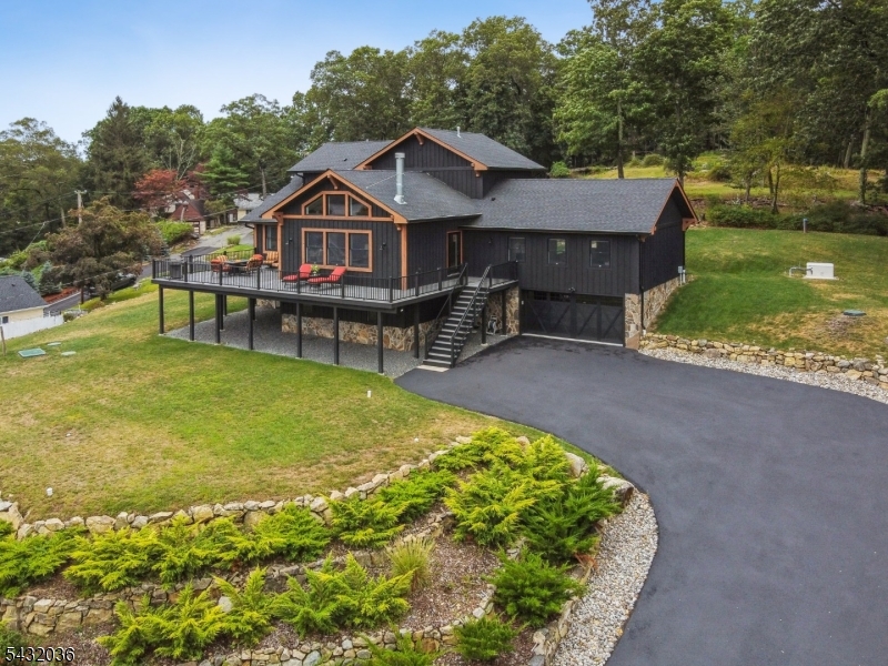 Welcome to this Laketastic custom retreat at 8 Sutton Road in beautiful Hopatcong! Built in 2022, this stunning 3 bedroom, 3 bath home offers approximately 2,900+ sq ft of beautifully designed living space with an open concept layout, soaring cathedral ceilings, and exceptional craftsmanship throughout.  Designed for both everyday comfort and entertaining, the spacious living room flows seamlessly into the dining area and gourmet kitchen creating the perfect gathering space. The luxurious primary suite features a walk-in closet and private bath, while additional bedrooms provide flexibility for guests, home office space, or extended living.  Enjoy the true Lake Hopatcong lifestyle with seasonal lake views, lake privileges, and outdoor spaces ideal for relaxing or entertaining. The expansive deck overlooks the peaceful setting and offers the perfect place for morning coffee, sunset evenings, and summer gatherings. Situated on a beautiful oversized lot with mature surroundings, this property combines privacy, elegance, and convenience.  Whether you are searching for a year-round residence, weekend getaway, or entertainer's dream, this exceptional home captures the essence of Laketastic living with style, comfort, and timeless appeal.