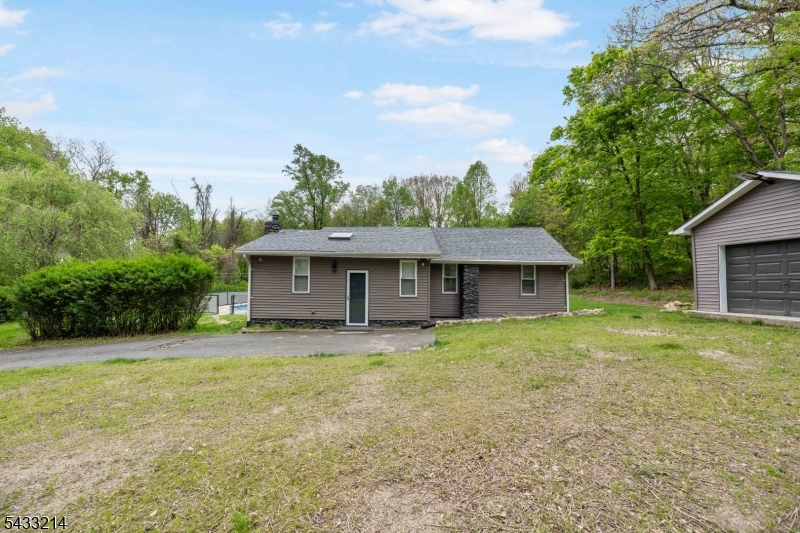 If the feeling of seclusion is your goal, you'll enjoy this renovated 2024 ranch in the Berkshire Valley section of Wharton, set among the wooded hills of the NJ Highlands. This exceptional retreat is surrounded by acres of dense, verdant woodland with virtually no neighbors in sight: a rare level of seclusion that is nearly impossible to find this close to everyday conveniences. Lake Hopatcong and hiking trails are just minutes away, and the Mt Arlington train station sits roughly five miles from your door, making commuting a seamless part of your day even as you enjoy a lifestyle that feels worlds removed from the ordinary. Inside is a breath of fresh air with tones of bright modern minimalism throughout. The eat-in kitchen includes a unique counter w/seating perfect for casual dining. Open living and dining area boasts warm light wood floors, recessed lighting, modern ceiling fan & sliding glass doors to private deck overlooking wooded backyard. 3 bedrooms continue the cohesive, contemporary feel throughout the home. The full bathroom is impressive with its spacious glass-enclosed walk-in shower w/built-in bench and stackable laundry units. The finished basement is your blank slate ready to make your own. Another full bathroom completes the lower level. Outside you'll enjoy the salt water in-ground pool & concrete patio, all backed by dense forest stretching up the hillside. Detached garage for storage & workspace. A rare Highlands retreat that must be seen.