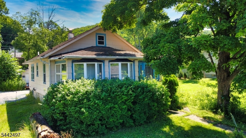 Here's a fantastic fixer-upper in a great location, at an attractive price. The home sits on a lovely half acre corner lot with a view of Clove Lake, and offers a new furnace and water heater, as well as a spacious garage and plenty of parking. The home has a great layout and the original wood floors under the carpets. The unfinished walk up attic also offers a ton of storage as well as potential for expansion. Bring your vision, your toolbox, and your paint brush and make this house your home! Property is being sold strictly as-is. Also known as 52 Clove Ave.