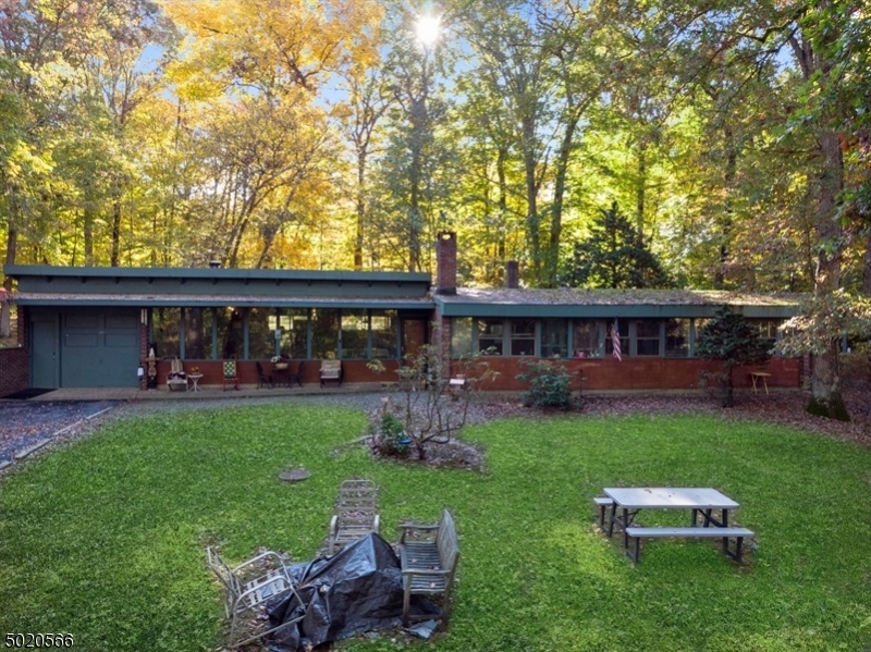 RUSTIC HIDEAWAY! Your own woodsy chalet, less than 1 hr from NYC. Total privacy and solitude, yet less than 2 miles from Morristown Green. Minutes to NJ Transit Midtown Direct trains to Manhattan. This 2.4 acre property with a Mid Century Modern home has 3 bedrooms and 2 bathrooms, situated in an area completely surrounded with non-buildable wooded land. A huge front lawn boasts a 1 acre pond with fountains. Get your skates out for ice-skating in the wintertime. The front has large windows along the expanse of the home, making for a beautiful setting in all seasons. In winter, cozy up to the wood burning stove in the living room with a massive wood beam ceiling. The updated kitchen comes with all appliances, granite counters and breakfast bar. Plenty of storage. All bedrooms have views of pond. Must see!