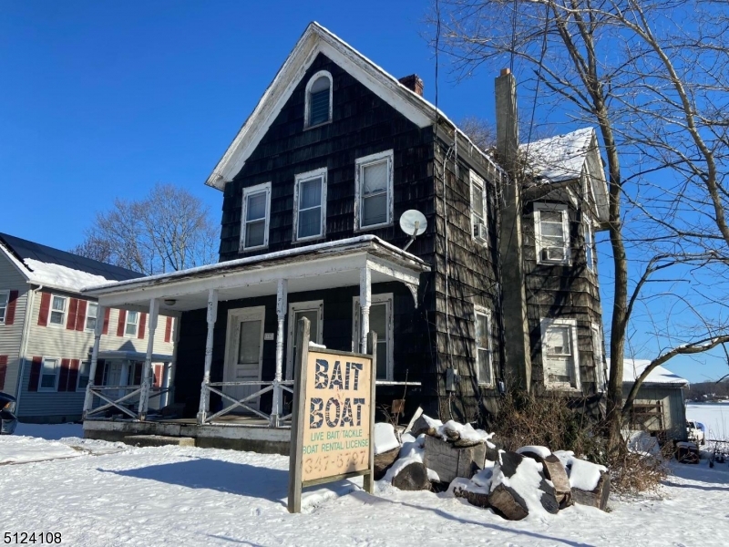 Commercial opportunity on the shores of Lake Musconetcong.  2 bedroom house with lake frontage and plenty of parking.  Great location bordering downtown Stanhope and Netcong.  Currently being used as a bait shop.  AS-IS SALE.