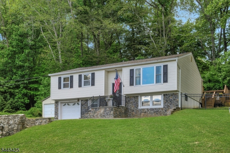 Move right into this beautifully maintained 3-bedroom bi-level, ideally situated on a quiet street in desirable Budd Lake. Offering the perfect blend of comfort, privacy, and convenience, this home provides peace of mind with major updates already completed, including a new roof (2025) and HVAC system (2019), both backed by transferable warranties.The inviting  main level features hardwood flooring throughout the living and dining rooms, creating an inviting space for both everyday living and entertaining. The adjacent kitchen and dining area open directly to the deck, making it easy to enjoy outdoor meals, relax with your morning coffee, or take in the peaceful wooded backdrop.The private backyard is a true retreat, surrounded by mature trees that provide natural beauty and exceptional privacy. A storage shed with electricity offers flexible space for hobbies, projects, or additional storage.With 3 bedrooms, 1 full bath, and 2 half baths, public sewer, and a location that combines neighborhood charm with everyday convenience, this home checks all the boxes. Enjoy top-rated Mount Olive Township schools, nearby parks and recreational amenities, convenient shopping and dining, plus easy access to major highways and NJ Transit for commuting.