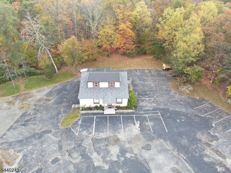 Exceptional Commercial Opportunity in Sparta's Economic Development District. Position your business for success in this freestanding commercial building located in Sparta Township's desirable Economic Development (ED) Zone. Situated on a generously sized site with abundant on-site parking and surrounded by mature woodlands, this versatile property offers a unique combination of privacy, accessibility, and flexibility. The building features expansive open-concept space, multiple private and support areas, restrooms, storage facilities, and a commercial kitchen/preparation area, making it suitable for a wide range of owner-users, investors, educational organizations, professional offices, training centers, fitness operators, research facilities, and other permitted commercial uses. The ED Zone permits a broad range of office, research, warehousing, light industrial, indoor recreation, health club, and business-related uses, creating significant value-add and redevelopment potential. Convenient access to Route 15 and regional transportation corridors enhances the property's appeal for both local and regional operations.  A rare opportunity to acquire a highly adaptable commercial asset in one of Sparta's established business districts.