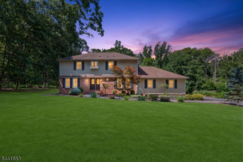 Spectacular move-in ready Colonial in Hampton on 2.23 private wooded acres offering exceptional privacy and serene natural setting. Gleaming hardwood floors throughout, gourmet kitchen featuring granite counters, stone backsplash, and premium stainless appliances. Beautifully appointed ceramic tile baths with granite vanities and custom finishes. Anderson windows, central vacuum system. Open floor plan with soaring high ceilings flows seamlessly from spacious living areas to formal dining room, generous den ideal for home office or library, and exceptional sunroom overlooking the grounds with full recreation room below perfect for entertaining and gatherings. Primary suite features walk-in closet, full bath with spa details, and private retreat space. Four generously proportioned bedrooms with abundant natural light and quality throughout. Wood-burning fireplace adds warmth and character. Finished sunroom and rec room with unfinished basement offering utility room and ample storage for future expansion. Heated in-ground pool with surrounding patio ideal for outdoor entertaining year-round. Expansive deck for morning coffee or evening relaxation. Two-car attached garage with finished space. Well-maintained vinyl siding. Mature landscaping creates natural privacy buffer from neighbors. Convenient location minutes from Route 78, excellent schools, shopping, fine dining, and commuter access. Truly exceptional property.