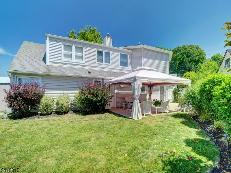 Large 2,550 square foot (Per Tax Assessor's Records) expanded Colonial in the Nixon Park area. Open concept floor plan. freshly painted, new flooring, updated full bath.  4 bedrooms 2 full baths. 1st level- living room, formal dining room, eat in kitchen with breakfast counter, some new appliances,  2 bedrooms and an updated full bath , 2nd level - 2 bedrooms and full bath  (very large 4th bedroom with sitting area , large closet. plenty of storage space),  Lots of natural light. Walk out to a covered patio with vinyl fenced  in yard. lots of privacy, professionally landscaped with night lighting in the flower beds. 1 car detached garage. 2 separate driveways.  Close to schools, shopping, dining, major highways, Close to Edison/Metuchen train stations making commuting to NYC easy.