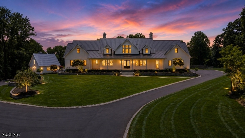 Welcome to Knightsbridge Estate. Set behind a gated entrance in Colts Neck's Clover Hill section, this approximately 15,000 sq ft modern farmhouse estate compound is designed for luxury living, entertaining, wellness, equestrian pursuits, and animal-property use. The residence offers 7 bedrooms, 8 full baths, 3 half baths, soaring ceilings, black-framed windows, radiant-heated floors, a 3-level elevator, sauna, gym, wine room, generator, solar, and 5 fireplaces. The primary suite serves as a private retreat with a spa-inspired bath. Outdoor amenities include an in-ground pool, trails, dog wash room, fenced dog run, and expansive open acreage. A fully equipped 1950s-inspired casita includes an eat-in kitchen, bedroom, and full bath, providing separate guest accommodations. A 5-stall barn supports equestrian and animal-property use. A detached building currently configured as a dance/yoga and wellness studio offers flexible use and may be converted back to a 6-car garage. A rare offering combining acreage, equestrian facilities, guest accommodations, wellness amenities, and exceptional versatility in Colts Neck.