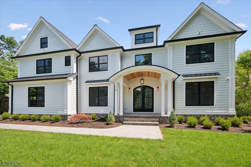 This stunning new construction residence sits on a sprawling 1-acre lot and boasts impeccable craftsmanship throughout. With 7 bedrooms, 6 full bathrooms, and 2 half baths spread across 4 levels, it offers ample space and luxury living. The kitchen features custom white oak cabinets and top-of-the-line stainless-steel appliances from Wolf, Sub-Zero, Fisher & Paykel, and Thermadore. A highlight is the exquisite dry bar with an ice machine and refrigerator, alongside a walk-in pantry with quartz countertops and a white oak butlers pantry with sink and dishwasher.  Additional features include custom white oak lockers in the mudroom and a first-floor bedroom with an ensuite bathroom.On the second floor, you'll find a refined primary bedroom with soaring 15-foot ceilings, a gas fireplace, and a cozy sitting area. Oversized Anderson windows flood the space with natural light. The primary bathroom is a sanctuary with heated floors, a soaking tub, a separate toilet closet, dual vanities, and a zero-entry shower. Ample closets abound, with a bonus room on the third floor and a spectacular lower level that includes a wellness room, another bedroom with a full bath, laundry hookups, a kitchenette, and a spacious recreation room.The flat level yard offers plenty of room for a pool, playground, and various outdoor activities.