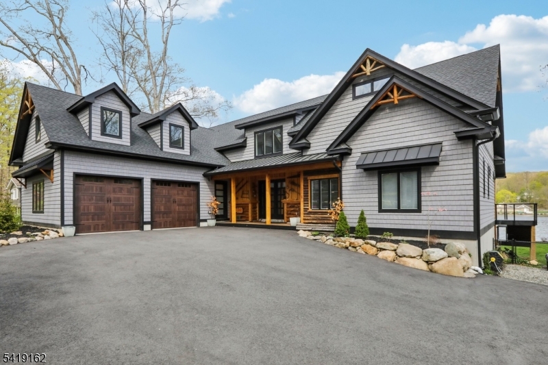 Welcome to your dream lakefront retreat, 29 miles from NYC. Completely rebuilt, this stunning 5-bedroom, 5-bathroom home offers perfect combination of luxury, comfort, & waterfront living. Set along beautiful Cupsaw Lake, you can enjoy breathtaking water views & a vibrant summer lifestyle. Inside, the home features two primary suites (1 on the 1st Fl), & another on the 2nd floor; ideal for hosting guests. The high-end kitchen is designed for both everyday living & entertaining, offering top-of-the-line finishes, premium appliances, & incredible views of the lake. Upgrades include whole house surround sound, hardwired ethernet throughout, & modern mechanical systems for efficiency and convenience. Spacious living areas, beautiful bathrooms, and exceptional craftsmanship makethis home truly move-in ready. Step outside to your private lakeside escape, perfect for kayaking, swimming, fishing, and taking in the peaceful surroundings. In addition, the seller is offering up to $40,000 toward an interest rate buydown creating a meaningful opportunity to lower your monthly payment while enjoying this one-of-a-kind lakefront property Cupsaw Lake offers a welcoming community w/ summer events, clubhouse amenities, & endless opportunities for outdoor enjoyment. Whether commuting to NY or working remotely, this home delivers the best of both worlds: a peaceful lakefront lifestyle w/convenient access to NYC. Start making memories at Cupsaw Lake & experience a lifestyle unlike any other.