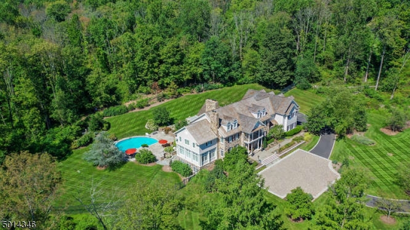 Welcome to "Springcroft"- an absolutely stunning stone front Custom Colonial that is the ne plus ultra of gracious living- with 8,100 sq ft of commodious living space on the two upper floors, plus the added luxury of a sprawling, superbly finished lower level w walkout to a sparkling in-ground swimming pool & expansive bluestone patio w pergola & outdoor kitchen. Privately sited on nearly 5.2 acres in a coveted, commuter-friendly east Chester Twp estate neighborhood w the added pedigree of a Far Hills mailing address. 12 rooms, 5 bedrooms, 7 1/2 baths, 4 fireplaces, open floor plan great room, gorgeous designer kitchen, library, magnificent master bedroom suite w sitting room, volume ceilings & hardwood flooring throughout.  4 car attached garage, convenient elevator, FIOS,& 48KW whole-house gas generator.