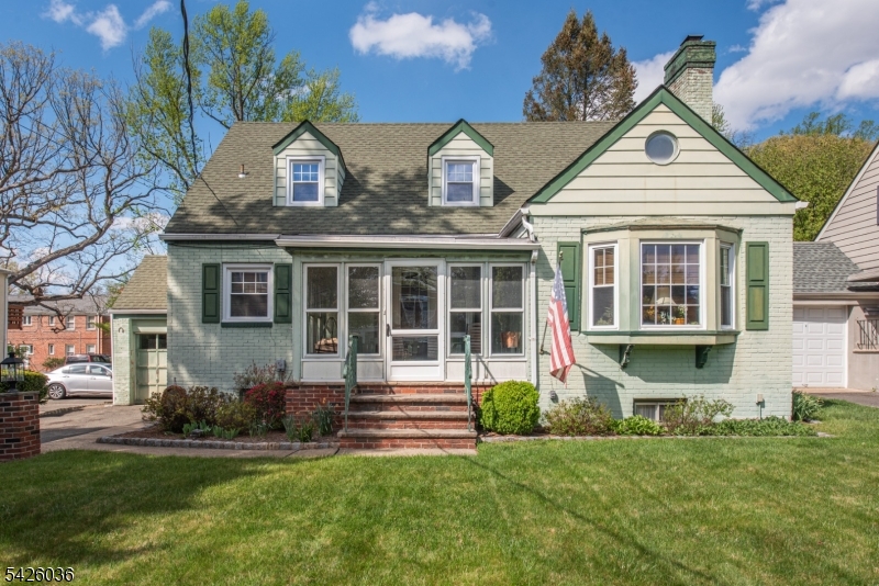 In-town Cape Cod, ideally located across from Morristown Medical Center on Franklin Street, a designated Quiet Zone. This charming home offers 3 bedrooms plus a first-floor den that can easily serve as a 4th bedroom. The spacious layout features a large living room with fireplace, formal dining room, and eat-in kitchen, along with a bright enclosed front porch - perfect for relaxing. Hardwood floors lie beneath the carpeting, offering the potential to restore their natural beauty. Additional highlights include a partially-finished basement, central air, an attached garage and an expansive, private level lot. An exceptional location for commuters, with easy access to major highways and public transportation, while still enjoying the charm of an established neighborhood close to everything Morristown has to offer.