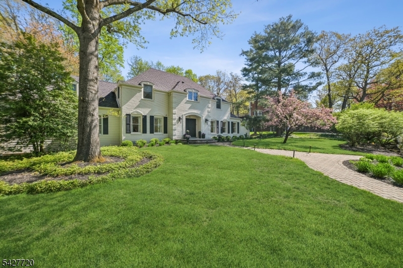 MAGNIFICENT FRENCH COLONIAL * SHORT HILLS CUL-DE-SAC * Nestled in one of Short Hills' most prestigious enclaves, this stunning French Colonial was meticulously reimagined & renovated from top-to-bottom in 2022 and offers an exceptional blend of classic elegance and modern luxury. Set atop beautifully landscaped property, this home features white oak floors, all-new recessed lighting, designer fixtures, and a seamless open-concept layout. A welcoming foyer with sweeping staircase leads to elegant formal rooms, including a dining room with custom lighting and a versatile living room with full bath perfect as a first-floor guest suite or office. The gourmet kitchen is a showpiece with custom cabinetry, quartz countertops and backsplash, waterfall-edge island, farm sink & Dacor appliances. A spacious pantry, oversized mudroom, and first-floor laundry add convenience. The breakfast room opens to a bright family room w/ gas fireplace, built-ins, and oversized windows. Upstairs, the luxurious primary suite offers an oversized closet/dressing room, and a spa-like bath with soaking tub and glass shower. Finished LL includes a recreation room, office or guest space, full bath, 2nd laundry, and storage. Outside, enjoy mature plantings, specimen trees, fenced garden, and porcelain/natural stone deck for outdoor entertaining w/ outdoor kitchen/Coyote gas grill. Ideally located near Hartshorn Elementary & the Short Hills train, this turn-key home offers timeless design and modern living.