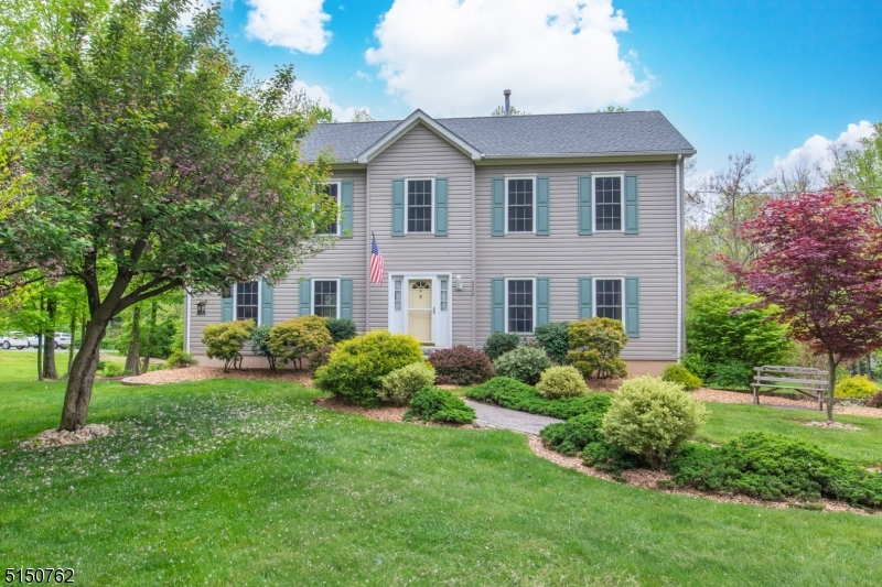 Large impeccable center hall colonial set back from the road on a gorgeous property. This four bedroom home offers a beautifully updated in-law suite giving the ideal space for an optional fifth bedroom. There is nothing to do but unpack your bags. You are welcomed to a spacious entryway with coat closet. The eat-in kitchen with island and granite countertops is the heart of the house. The house has great flow as the kitchen is open to the living room with a gas fireplace and connects to the family room. There is a walkout to the deck with built in canopy and large windows overlook the private backyard. A dining room, powder room and laundry complete the level. Upstairs is the primary bedroom with a large en-suite with stall shower, soaking tub and double vanity. There are three additional bedrooms and a full bathroom. The lower level offers an additional full kitchen with granite counters, a living area, bedroom space and fully updated bathroom with bench seat and two shower heads. It offers a slider to a private patio area. The home has a new roof (2021), a spacious two-car garage and a large shed with electricity. The professionally landscaped yard also offers a fire pit area giving the property a private estate feel. Close to Martinsville this home is close to everything and in an ideal commuting location. Don't let this one pass you by.