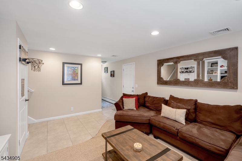 Welcome home to this beautifully renovated 4 Bedroom / 4 Bathroom Split Level situated at the end of a cul-de-sac in highly sought after Little Falls. Featuring hardwood floors, central AC & baseboard heat, ample sunlight throughout the day, custom window treatments, one car attached garage w/ four car driveway, and stunning backyard, this home is sure to please. Main level features front porch, entry foyer, living room, dining room, stunning Chef's kitchen w/ French doors to backyard, and deck. Chef's kitchen includes SS appliances, quartz countertops, custom cabinets, center island, and sitting area. Second floor features junior suite with full bathroom, two spacious bedrooms, and a beautifully renovated full bathroom. Third floor includes spacious Master bedroom w/ two walk-in closets and gorgeous spa-like full bathroom w/ soaking tub and stall shower. Ground level features family room w/ entrance to attached one car garage and full bathroom. Fully finished basement includes family room, laundry, storage, and utilities. Completing this home is a beautiful, lush backyard perfect for entertaining and features professional landscaping, deck w/ jacuzzi and playground. Located near plenty of shopping, restaurants, public transportation, major highways, and schools, this is truly a home you don't want to miss!