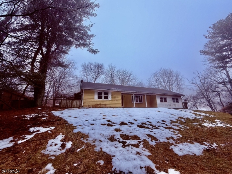Escape to your own private sanctuary with this 2 bedroom ranch nestled deep within a lush, wooded lot. Offering true single-level living, this home is a quiet retreat for those seeking peace and privacy. While the interior is ready for your personal touch and updates, the solid bones and surrounding mature trees provide the perfect foundation for a cozy cabin or modern woodland hideaway.