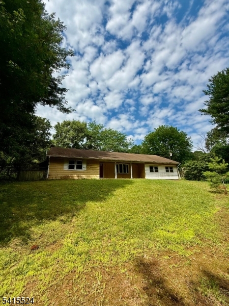 Escape to your own private sanctuary with this 2 bedroom ranch nestled deep within a lush, wooded lot. Offering true single-level living, this home is a quiet retreat for those seeking peace and privacy. While the interior is ready for your personal touch and updates, the solid bones and surrounding mature trees provide the perfect foundation for a cozy cabin or modern woodland hideaway.