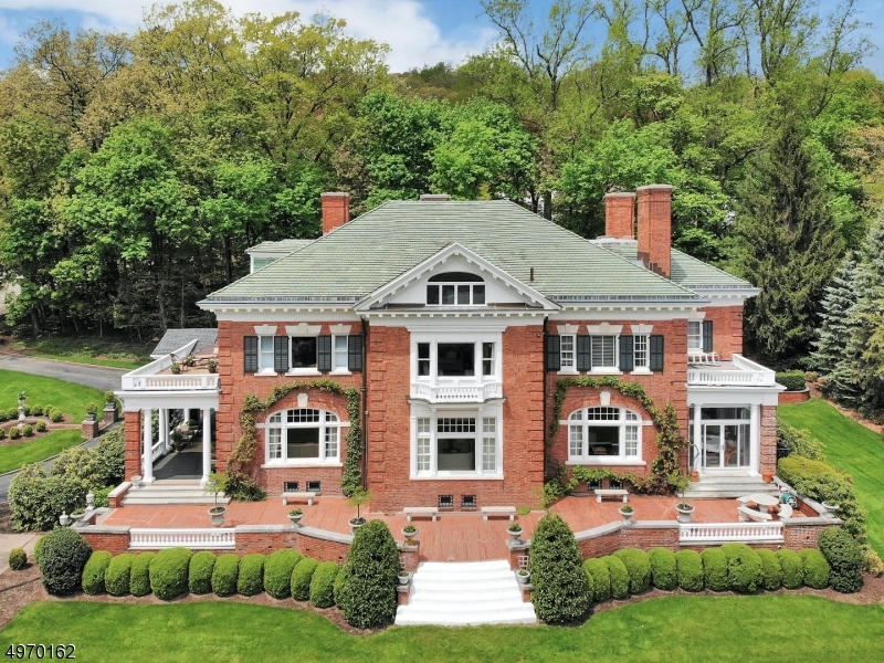 One of Montclair's finest homes: Edgewood Terrace! Grosvenor Atterbury & Walter Leslie Walker, architects, 1905. This magnificent red brick Georgian has breathtaking city views - especially at night. Perched on the slopes of the First Watchung Mountain and within the National Register of Historic Places "Mountain District" of "high-style mansions".  Grand rooms with elegant proportions and original details made into comfortable contemporary living. Many updates and system upgrades from heating/cooling to a new movie theatre. Taste and elegance in a truly stunning home.