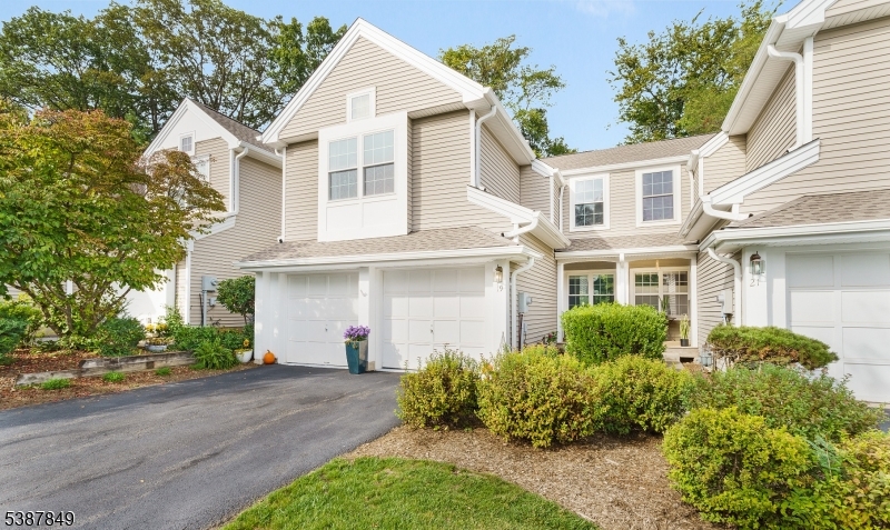Absolutely spectacular Brentwood model townhome in the desirable Woodmont community. This open, airy floor plan offers soaring ceilings, abundant natural light, and seamless flow to a private patio with tranquil wooded views and visiting wildlife. Freshly painted top to bottom in 2024, updates include newer windows, a 2020 sliding glass door, and a remodeled kitchen with custom cabinetry, granite countertops, tile backsplash, recessed lighting (2024), under-cabinet lighting, and upgraded hardware. Stainless steel Bosch dishwasher, brand new 2024 range & microwave, and French door refrigerator w/dual freezer drawers complete the space. The main level features newer wood flooring, designer light fixtures, & a dramatic two-story living room with a gas fireplace as the centerpiece. Upstairs offers new carpet (2024), three spacious bedrooms w/custom closets (2021), & a primary suite w/ soaring ceilings, two closets including a walk-in, & a spa-like bath remodeled in 2017 with soaking tub, rain shower, and double vanity. The finished lower level provides a large recreation room, home gym or office space, plus a full bath. Additional highlights include washer and dryer, Nest thermostat, water softener, garage belt-operated openers replaced in March 2025, and roof, gutters, soffits, and fascia board replaced in Fall 2024. Two-car garage plus two driveway spaces and guest parking across. Fantastic location near shopping, schools, parks, and commuter routes this home is truly turn-key!