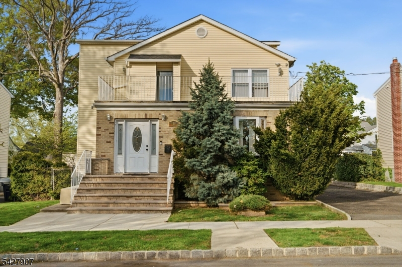This stunning and spacious custom Colonial offers the perfect blend of modern luxury and move-in-ready comfort. Sun-filled interiors showcase rich hardwood floors and a bright, open layout designed for both everyday living and effortless entertaining. The main level features a sophisticated formal dining room and a beautifully designed chef's kitchen complete with white cabinetry, granite countertops, a sleek tile backsplash, pantry, and stainless steel appliances. A first-floor bedroom, full bath, and private side entrance provide added flexibility for guests, home office use, or extended living arrangements. Upstairs, you'll find three generously sized bedrooms, including a tranquil primary suite with a sitting area, along with a tastefully updated full bath. The fully finished lower level expands the living space with a stylish family room, summer kitchenette, bonus or fitness area, laundry room, and a third full bath?ideal for extended stays, recreation, or flexible living needs. Additional highlights include a spa-like bathroom with a jetted tub and marble finishes, a fenced backyard with paver patio, private balcony, oversized 6+ car driveway, and a 2-car garage. Ideally situated near transportation, major highways, schools, and shopping for added convenience.