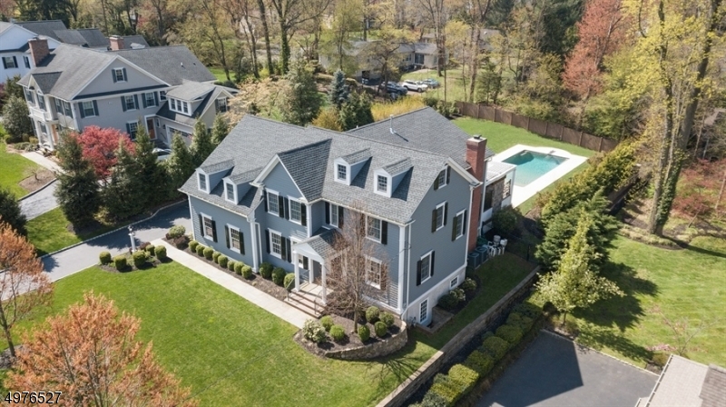 Vacation at home in this upscale Colonial with 6 bedrooms, 4.1 baths built by renowned W.P. Lloyd on a sought after street with superior quality, open concept, numerous amenities & top rated schools! This dream home loaded with deatail boasts a large foyer, living room, dining room with butler's pantry, back stairs, mudroom, chef's eat-in kitchen with Wolf stove that opens to the family room with gas fireplace overlooking the resort style backyard with newer heated salt pool, large covered porch with gas fireplace & TV & a wonderful private yard for play, relaxing & gardening. Enjoy this second level with 5 bedrooms, 3 full baths & large master suite with 2 walk-in closets. The lower level has a rec room, bedroom, exercise room & full bath. Enjoy living everyday in this vacation like home with 5,395 sq ft!