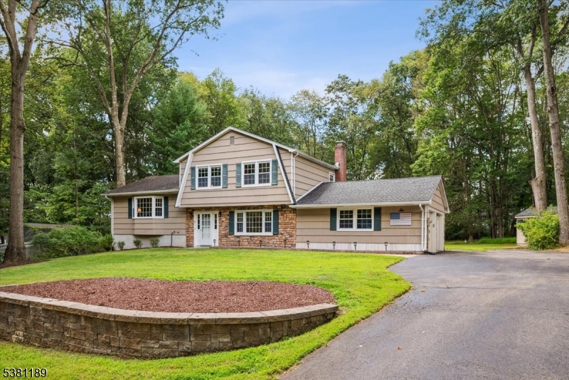 Beautifully Maintained Home in a Picturesque Neighborhood!  Wonderful Colonial-style split level home in Roxbury with 4 generous bedrooms, 1 full and 2 half baths and an attached oversized 2-car garage on a quiet tree-lined street.Impeccable landscaping and gracious curb appeal, with a paver patio, deck and big backyard around back for epic summer BBQs, gardening and games. Up a few steps from the welcoming front entry, the main level is awash with natural light and gleaming hardwood floors. The formal living room flows directly into a gracious dining area with sliding doors out to the deck for effortless warm-weather entertaining. Updated kitchen equipped with rich wood cabinetry topped with granite and a custom tile backsplash, along with recessed lighting and stainless steel appliances.Three bedrooms are on the upper level, serviced by a beautiful full hall bath with storage vanity and tub/shower combo. The primary bedroom also features a handy private half bath and walk-in closet. Downstairs, a finished lower level offers a cozy family room with brick fireplace, adjoining half bath, and sliding doors out to the patio perfect for every day relaxing and informal get-togethers. A fourth bedroom and garage access completes this level, and an unfinished basement houses laundry and utilities. Unbeatable location in a peaceful residential area, yet close to stores, restaurants, schools, parks, golf, highways and more.