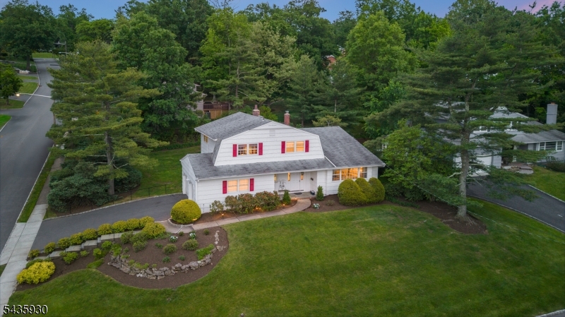 STYLISH 3-BED/2.1 BATH SPLIT-LEVEL HOME IN QUIET NEIGHBORHOOD HAS GREAT WELCOMING FEEL WITH FLOWING ROOMS & WELL-MAINTAINED KITCHEN & BATHS. Formal Living Room sits off tiled Foyer (w/ Powder Room & Coat Closet) & features hardwood floors, a wall of windows framing wide southern vistas & vaulted ceiling that stretches up to meet the raised Dining Room carrying natural light all the way through. Pristine eat-in Kitchen offers cherry wood cabinets, granite countertops, tumbled stone tile backsplash & stainless steel appliances including gas range, with room for a table by exterior door to grass-covered backyard. Expansive Family Room on entry level is surely the heart of this home, featuring cozy stone fireplace, wall of bookshelves, ceiling spotlights for your art collection & access to oversized Attached 2-car Garage as well as large paver stone patio out back. Bedroom wing is an easy half-staircase up from Dining Room & has 3 generously sized rooms with hardwood floors under carpet in two. Primary Suite has 2 closets & attached fully tiled bath with walk-in shower. Full Hall Bath is clean & updated with tub/shower combo & a convenient laundry chute under the vanity. Basement Level features finished Rec Room, Laundry, large cedar-lined closet & lots of extra storage space. Recreation-lover's paradise close to three golf courses, Turtle Back Zoo & McLoone's Boathouse, parks, sports fields & South Mountain Reservation! Minutes from NYC train & highways for easy commuting.