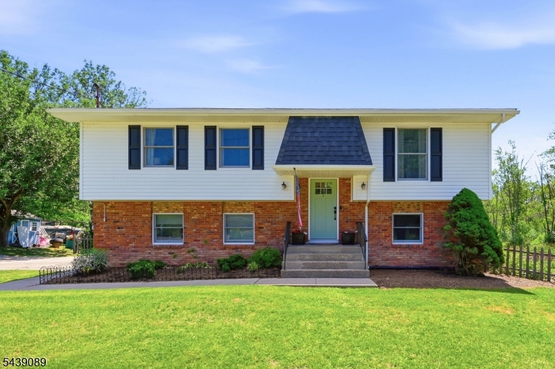 Well maintained 3 bedroom, 1.5 bath bi level situated on a large corner lot in a quiet neighborhood just behind Hampton Commons and minutes from downtown Newton, shopping, dining, and major conveniences. This brick and vinyl home offers a functional layout with plenty of living space both inside and out. The main level features original hardwood floors, a spacious living room, a cozy dining / breakfast area, and an updated eat-in kitchen with granite countertops, stainless steel appliances, and a sink w window overlooking the backyard park like setting. Double doors off the breakfast area lead to the deck creating the perfect spot for morning coffee or outdoor dining. Three bedrooms and a recently renovated full bath with a tiled tub/shower and oversized marble-top vanity complete the main level. The lower level offers a large family room with newer shiplap accents, updated trim work, a wood-burning stove, and sliders leading to a newer deck and the backyard. Also on this level are a half bath, a large den or potential 4th bedroom with large closet (not pictured), laundry area, and direct access to the attached garage. Outside, enjoy the fenced backyard that backs to a 1,000 acre wildlife management area with raised garden beds, peony garden, playset and shed with plenty of room to relax, entertain, or play. A great combination of location, space, and updates in a desirable Hampton Township neighborhood. New roof and vinyl siding 2021