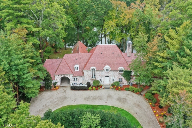 Majestic FRENCH MANOR ESTATE located on WATERFRONT property on prestigious North Pond in most coveted neighborhood in Short HIlls.  Circular driveway and elegant double doors lead into grand hallway with elegant circular staircase. Magnificent water views from almost every room including the first floor formal living room w/ wood burning fireplace and floor to ceiling french doors, dining room, sunroom, family room, kitchen w/ ss appliances and butler's pantry, library and private patio.  Second floor boasts a Master Suite with 2 baths, 2 walk in closets and gorgeous wood paneled office. Additional 4 bedrooms, study area and three baths on the second floor.  Large walkout basement includes finished rec room and additional bedroom and bath.  Luscious backyard oasis and multiple stone patios complete this stately residence.  Do not miss this RARE opportunity to own this regal residence!