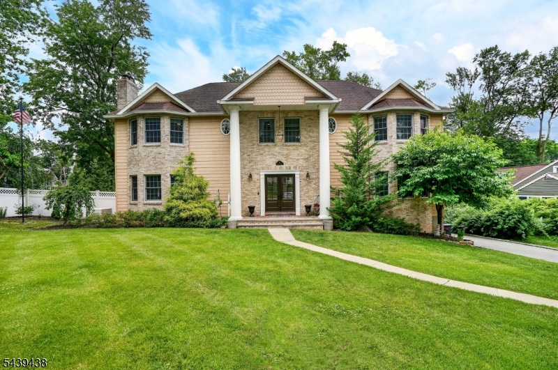 Nestled in a picturesque park-like setting and conveniently located near local amenities, this impressive home offers spacious living and timeless elegance. A grand foyer with a sweeping staircase creates a stunning first impression, leading to a gracious living room with a fireplace and a formal dining room ideal for entertaining.The expansive kitchen features a large eat-in island and a separate breakfast area, providing plenty of space for casual dining and gathering. The first floor also includes two generously sized guest bedrooms and two full bathrooms, offering comfort and flexibility for family and visitors.Upstairs, the luxurious primary suite boasts an ensuite bathroom and an attached den, creating a private retreat. Three additional guest bedrooms and two more bathrooms complete the second level, providing ample space for everyone.The finished lower level is designed for recreation and relaxation, featuring a spacious entertaining area with a home theater and wet bar. A separate gym and an additional bathroom add even more versatility to this exceptional home.Combining generous living spaces, elegant details, and a highly desirable location, this remarkable residence offers the perfect setting for both everyday living and memorable entertaining.
