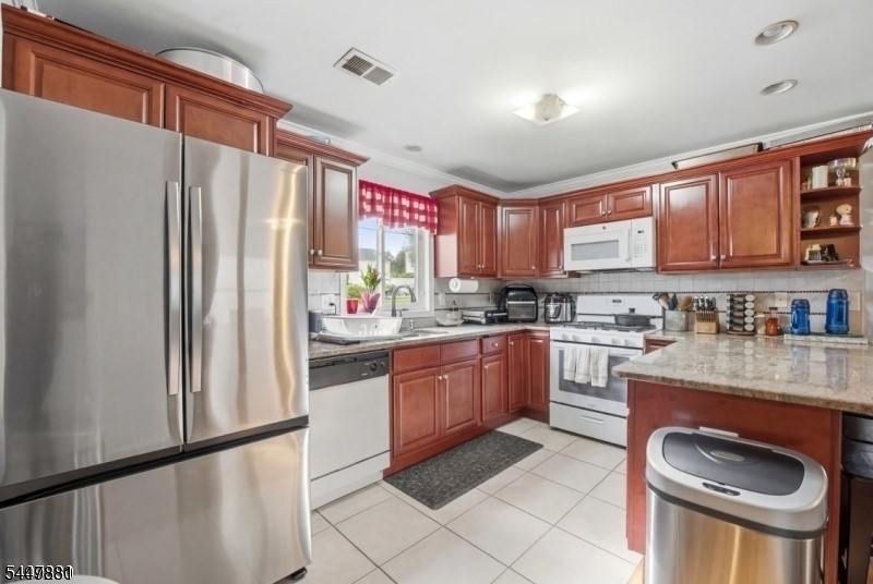 Newer Two-Family in a Prime Elizabeth Location! Welcome to this beautifully maintained newer 2-unit dwelling, offering two spacious apartments, each featuring three generously sized bedrooms, including a master bedroom with a private bath. Both units boast hardwood floors throughout the living and dining rooms, a spacious kitchen, central air conditioning, and forced hot-air heating for comfort and convenience. Attached garages provide ample parking, plus a bonus recreation room, perfect for a home gym, office, or entertainment space. Step outside to a fully fenced rear yard, ideal for entertaining, relaxing, or enjoying outdoor gatherings. Close to public transportation, including the North Elizabeth Train Station, with easy access to major highways, shopping, restaurants, and more. A fantastic opportunity for owner-occupants or investors alike. Schedule your private showing today; this one won't last!
