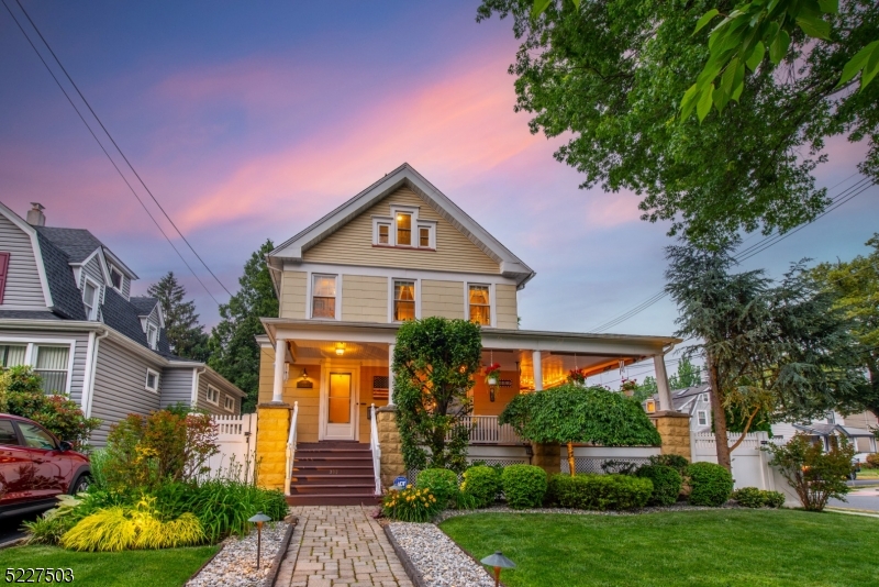 Stunning Large Colonial with Architectural charm on large corner lot, with 2 Car Garage and Driveway! This home has been meticulously updated and features a spacious layout, high ceilings, wood floors, architectural moldings/doors/hardware, and 4 levels of living. Beautiful wrap-around front porch perfect for enjoying your cup of coffee in the morning, spend lazy afternoons relaxing, or entertaining in the evening. As you enter the spacious foyer you're greeted by a beautiful Chestnut staircase and stained glass window, a Living Room, and a Dining Room with bump out. The Eat-in Kitchen and Butler's Pantry offer plenty of space for preparing meals and storage. Half bath completes this level. The second level has 4 generous bedrooms and a full bath. The third floor walk-up attic offers an office and the possibility to finish the remaining space for additional living, or keep it as is for storage. The basement has an amazing family Room currently set up as a sports bar theme, and an unfinished storage/laundry area w/ plumbing for an additional toilet. The Oversized 2 Car Garage including a loft, offers plenty of space for for your vehicles and storage, and park up to 4 cars in the driveway. Two Zone Central AC & Two Zone Forced Hot Air Heating. 5-zone Sprinkler system. Landscaping lighting. Conveniently located within close distance to center of town, transportation to NYC, Kean University, Newark Airport, Garden State Parkway, and Route 22. Don't miss this home!