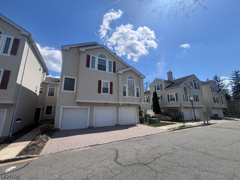 Beautifully maintained townhome located in the desirable Rose Arbor community. This move-in-ready residence offers 2 bedrooms and 2.5 baths, with a bright and airy layout designed for both everyday living and entertaining. The main level features a spacious living area and an abundance of natural light. The adjoining dining area flows seamlessly into the kitchen, which features a breakfast bar, stainless steel fridge and oven, plus generous cabinet space. Spacious living room with a wood-burning fireplace "as-is" condition. Upstairs, the primary bedroom is well-proportioned with a cathedral ceiling, en-suite bathroom and walk-in closet. The primary suite is enhanced by a recently renovated walk-in shower, adding a modern touch. Other features include: a private deck off the kitchen, offering a great outdoor extension of the living space, a one-car built-in garage with entrance into main floor, a private rear yard with view of trees, a short walk from the common parking lot to the entrance door, and plenty of guest parking within the complex. Ideally situated just moments from Morristown's vibrant downtown, with easy access to restaurants, theaters, parks, and local entertainment. A great opportunity to own in a prime location. Schedule your showing today.